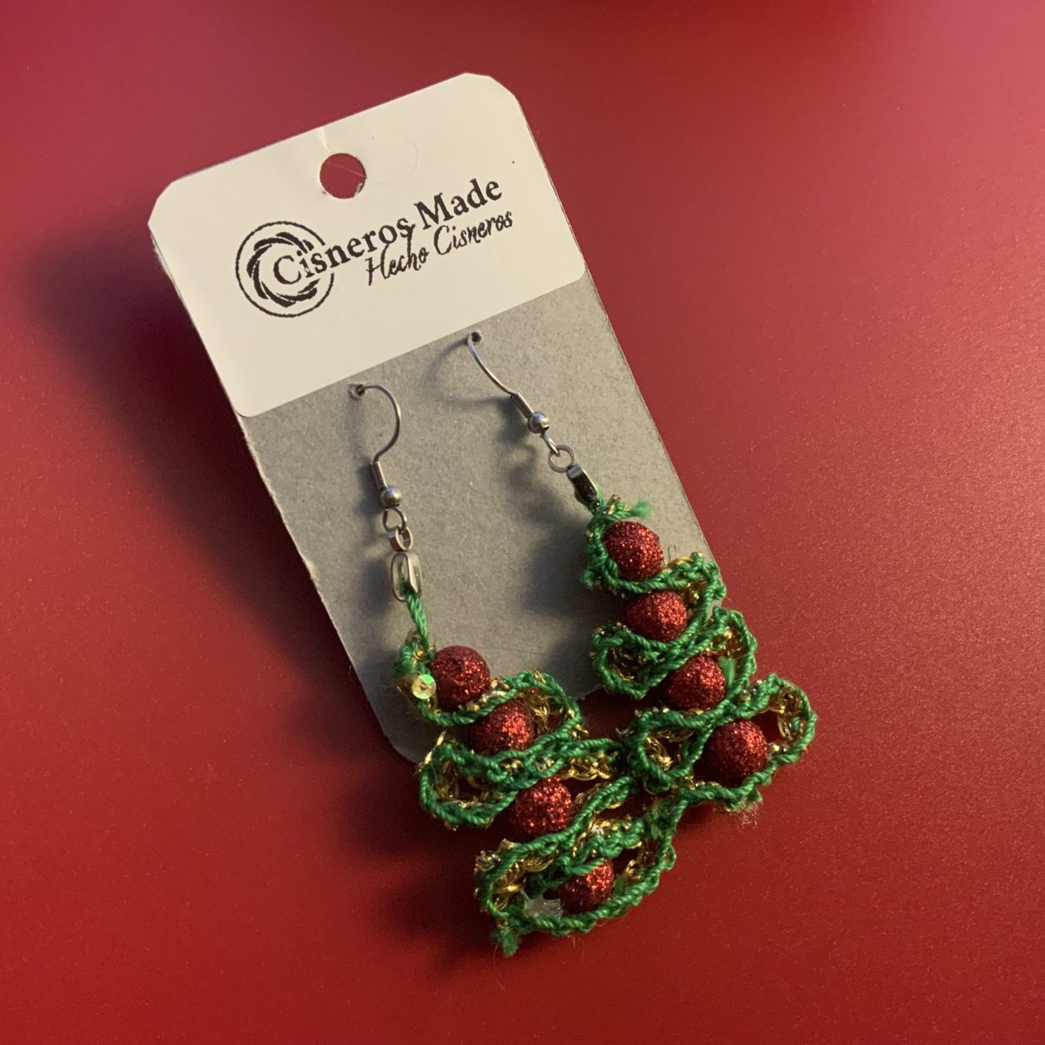 Green crochet Christmas tree earrings with red glittery beads and stainless steal hypoallergenic hooks